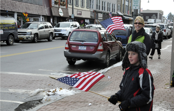 Parker Anthony and Jill Cardinale show the colors in anticipation of the Veteran's Day parade on Main Street in Lake Placid.