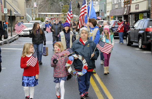 Cayla Teig and Norah Galvin walk with Dede Strack of the American Legion Auxiliary at the beginning of the parade.