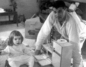 Father and daughter with early Easy Bake Oven, which resembled a conventional oven. Public domain