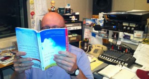 Mystery man reading at his desk (you know him as the morning voice of ncpr).