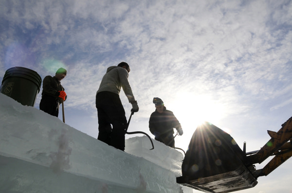 Off loading one of the ice blocks high up on one of the towers of the 2014 Saranac Lake Winter Carnival ice palace. Photo: Mark Kurtz, Saranac Lake, NY