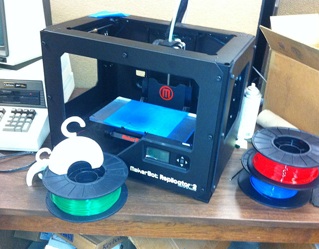 The 3-D printer in Clarkson's engineering lab. The spools hold the plastic-like coil that is fed into and melted by the "printer" before being squirted onto the turquoise building surface. Photo: Ellen Rocco
