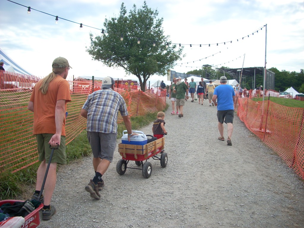 There's a lot of walking at this festival, but so many nice people to meet along the way!  This family is getting ready for a full night of music under the stars... but first, the long haul from the parking field to the big stage.  Everybody helps.....