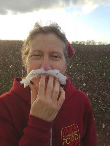Betsy stands in a cotton field with her cotton boll mustache.