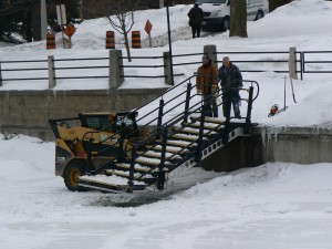 Workers remove an access stairway from the Rideau Canal Skateway  on March 1st.