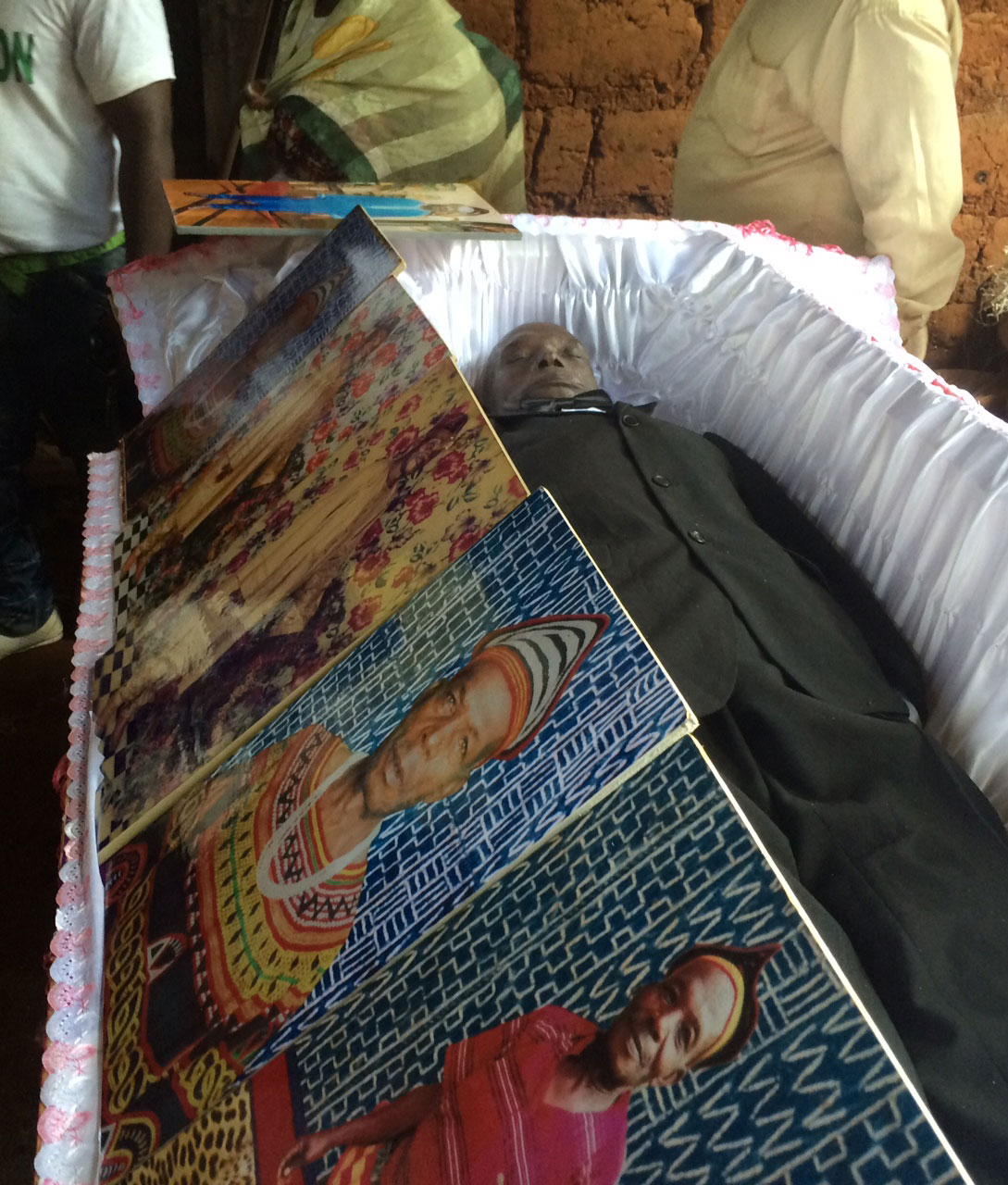 Portraits of Pa Jean surround his casket. Photo: Ellen Rocco