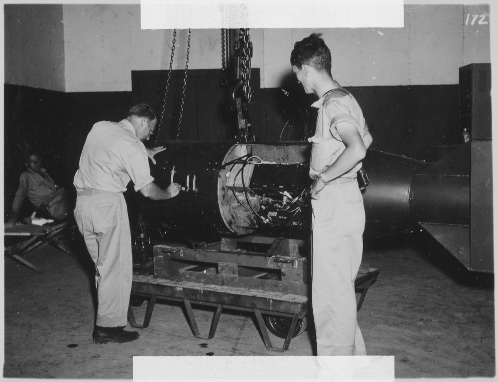Commander A. Francis Birch (left) assembles "Little Boy," the atomic bomb dropped on Hiroshima, while physicist Norman Ramsey watches. Photo: public domain