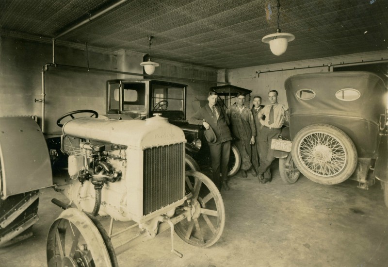Interior of the Hubbard Garage showroom floor, featuring a Model T car and Fordson Tractor. Circa 1920, Philadelphia, New York. photo: Philadelphia Historical Society Museum
