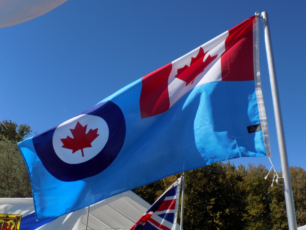 The Blue Ensign of the Royal Canadian Air Force.  Before the maple leaf flag was adopted in 1965, the flag in the top right would have been a British Union Jack.  The circle with the red maple leaf inside is called the roundel.  Photo by James Morgan