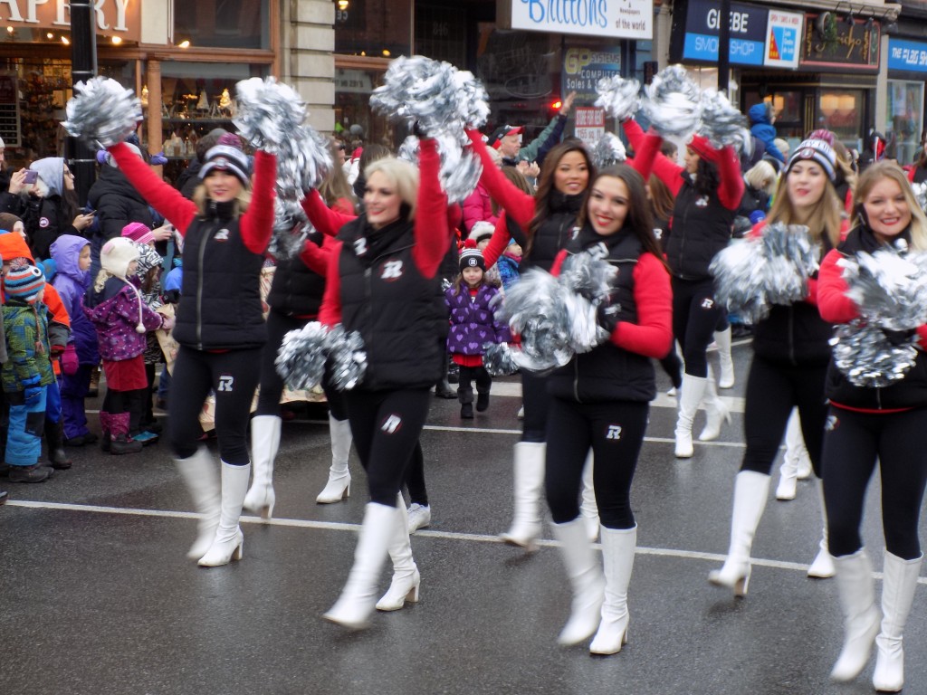 The Ottawa Redblacks Cheerleaders march down Bank Street.  Photo: James Morgan