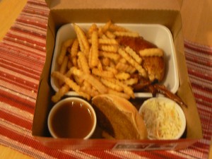 Box of Benny:  A Benny & Co. chicken breast take-out menu includes crinkle -cut fries, coleslaw, dipping sauce, and a roll.  Photo by James Morgan