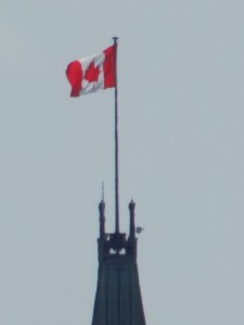 Pinnacle of power: the Canadian flag atop the Peace Tower on the Parliament Buildings in Ottawa.  Photo by James Morgan