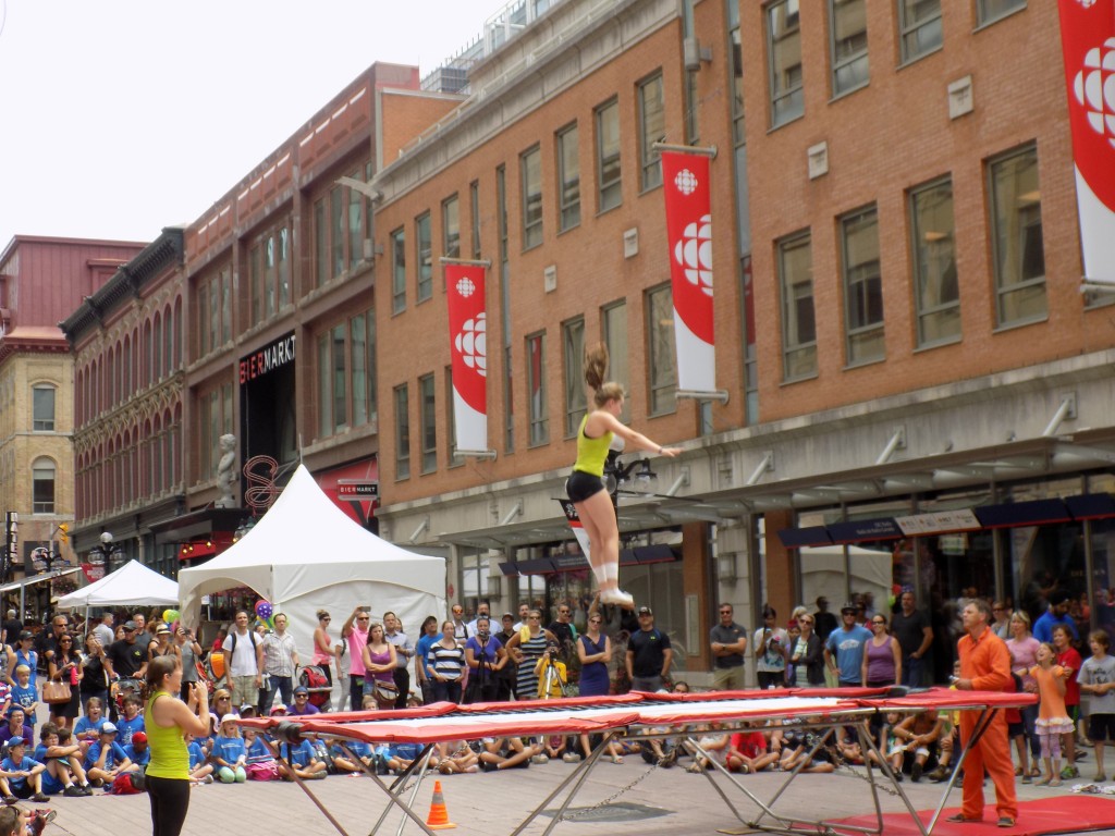 Spring Action in action at Ottawa Buskerfest.  At the left of the trampoline is Coach/performer Heather Ross McManus, who represented Canada at the 2004 Olympics in Athens, Greece.  At the right of the trampoline is Sean McManus, her Olympic coach and husband.  Photo by James Morgan