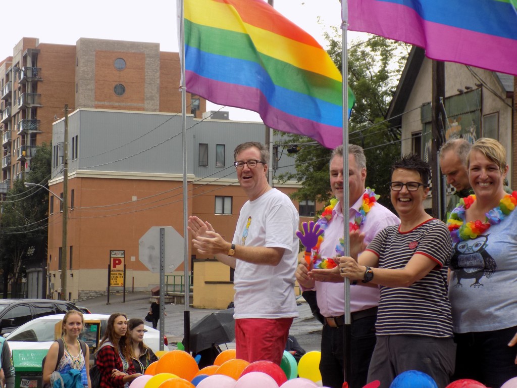 Ottawa Mayor Jim Watson, (standing under the Pride flag), with member of city council and staff.  Photo by James Morgan