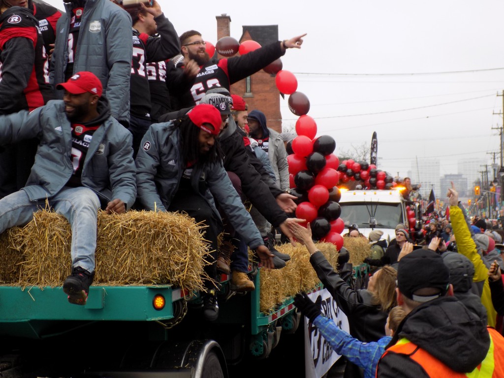 The parade was pretty informal.  Redblacks players reached out to fans along the route.  Photo: James Morgan