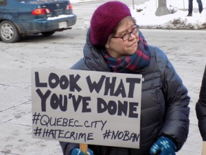 A protester's sign blames the President's order for the attack on a Quebec City mosque.  Photo: James Morgan