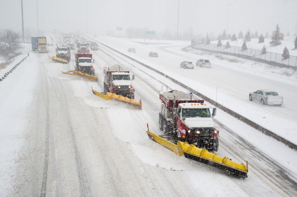 Snowplows clearing the road during a winter storm in Toronto. Road maintenance, snow clearance and motor vehicle license offices are provided by private companies in parts of Ontario. Photo: City of Toronto, Creative Commons, some rights reserved