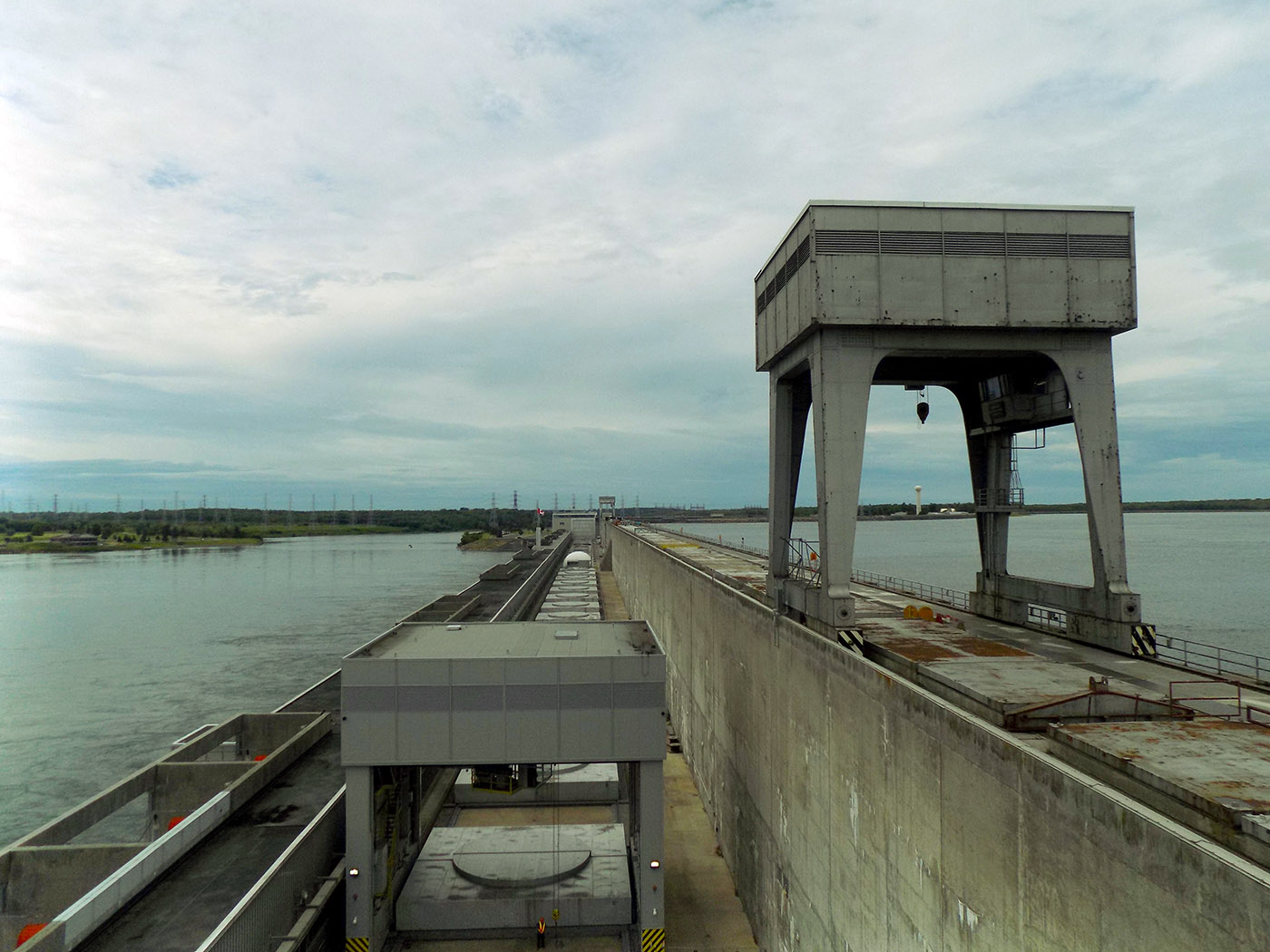 Looking across the Robert H. Saunders St. Lawrence Generating Station towards the New York Power Authority's Franklin Delano Roosevelt St. Lawrence station. The two high structures are gantry cranes that travel on tracks for generator maintenance. The square covers are the tops of the generator units. Photo: James Morgan