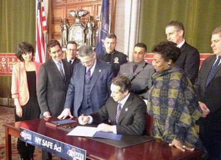 New York Gov. Andrew Cuomo signs the NY SAFE act into law in January of 2013. Photo: Karen DeWitt